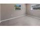 Bright bedroom featuring tile floors, two windows, and neutral paint at 1868 Pine Tree Dr, Edgewater, FL 32141