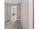 Hallway features neutral walls, tile flooring, and access to other rooms at 1868 Pine Tree Dr, Edgewater, FL 32141