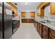 Updated kitchen features granite countertops, stainless steel appliances, and beautiful wood cabinetry at 1868 Pine Tree Dr, Edgewater, FL 32141