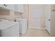 Laundry room showcasing washer, dryer, and cabinet storage at 1868 Pine Tree Dr, Edgewater, FL 32141