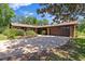 Charming single-story brick home featuring an attached two-car garage and beautiful landscaping at 1905 Pine Tree Dr, Edgewater, FL 32141