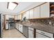 Bright kitchen featuring white cabinets, stainless steel appliances, and modern countertops at 1905 Pine Tree Dr, Edgewater, FL 32141