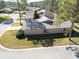 Aerial view of a residential property showcasing well-kept landscaping and the roof's skylight at 1918 Whisperwood Way # 10, Port Orange, FL 32128