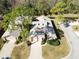 Overhead view of a home with two-car garage, landscaped lawn, and proximity to a pond at 1918 Whisperwood Way # 10, Port Orange, FL 32128