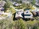 An aerial view of a residential area with well-maintained homes and mature trees lining the streets at 1918 Whisperwood Way # 10, Port Orange, FL 32128