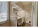 Bathroom with ample lighting, a sleek vanity, and storage space, all designed for comfort and efficiency at 1918 Whisperwood Way # 10, Port Orange, FL 32128