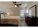 Cozy bedroom with hardwood floors, a ceiling fan, and bright windows at 1918 Whisperwood Way # 10, Port Orange, FL 32128