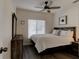 Comfortable bedroom with a modern ceiling fan, window with blinds, and wood-look flooring at 1918 Whisperwood Way # 10, Port Orange, FL 32128