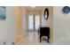 Welcoming entryway featuring elegant console table and double doors at 1918 Whisperwood Way # 10, Port Orange, FL 32128