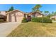 Charming single-story home with well-maintained lawn, established shrubbery, and two-car garage at 1918 Whisperwood Way # 10, Port Orange, FL 32128