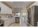 Bright kitchen with white cabinets, stainless steel appliances, and an open layout for easy entertaining at 1918 Whisperwood Way # 10, Port Orange, FL 32128