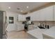 Modern kitchen with white cabinets, stainless steel appliances, and ample counter space at 1918 Whisperwood Way # 10, Port Orange, FL 32128