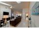 Open living room with vaulted ceilings, tile floors, and ample seating area at 1918 Whisperwood Way # 10, Port Orange, FL 32128