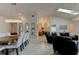 Open-concept living area with dining space, living room, modern lighting, and vaulted ceiling at 1918 Whisperwood Way # 10, Port Orange, FL 32128