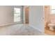Bedroom view to a walk-in closet and bathroom with natural window light at 208 Lagoon Mist Ct, Oak Hill, FL 32759