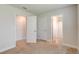 Bedroom showcasing multiple doors accessing the bathroom and closets at 208 Lagoon Mist Ct, Oak Hill, FL 32759