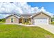 Beautiful single-story brick home with well-maintained lawn and attached two car garage at 208 Lagoon Mist Ct, Oak Hill, FL 32759