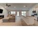 Open-concept living room flowing into the kitchen, creating an inviting space at 208 Lagoon Mist Ct, Oak Hill, FL 32759