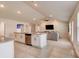 Open-concept layout with tile floors, kitchen island, and spacious living area at 208 Lagoon Mist Ct, Oak Hill, FL 32759