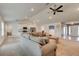 Open-concept living room with vaulted ceilings, a kitchen, and ample natural light at 208 Lagoon Mist Ct, Oak Hill, FL 32759