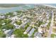 Picturesque aerial view shows a coastal community with houses, mature trees, and waterways in the background at 212 Due East St, New Smyrna Beach, FL 32169