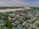 Scenic aerial view of a waterfront community near a river with a mix of residential homes at 212 Due East St, New Smyrna Beach, FL 32169