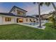 Beautiful backyard features a pool, outdoor kitchen, and covered patio, creating an ideal space for entertaining or relaxing at 212 Due East St, New Smyrna Beach, FL 32169