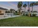 Backyard with a refreshing pool, manicured lawn, and ample space for outdoor activities at 212 Due East St, New Smyrna Beach, FL 32169