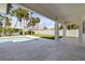 The modern backyard features an inviting pool, travertine tile, and tropical landscaping at 212 Due East St, New Smyrna Beach, FL 32169