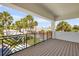 Expansive balcony with stylish railing, offering stunning views of lush greenery and neighborhood scenery at 212 Due East St, New Smyrna Beach, FL 32169