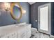 Bathroom with a marble vanity, mirror, and lighting at 212 Due East St, New Smyrna Beach, FL 32169