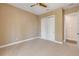 Comfortable bedroom features neutral carpet, a ceiling fan, and a closet for storage, creating a cozy retreat at 212 Due East St, New Smyrna Beach, FL 32169