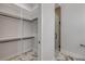 This walk-in closet is adjacent to a shower offering convenient access and ample storage space at 212 Due East St, New Smyrna Beach, FL 32169