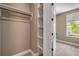 Spacious closet featuring built-in shelves and hanging rods, complemented by a well-lit interior for easy organization at 212 Due East St, New Smyrna Beach, FL 32169