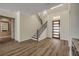 Open entryway with staircase, wood floors, and a modern door providing a welcoming ambiance at 212 Due East St, New Smyrna Beach, FL 32169