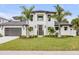Stunning two-story home with a modern design, lush landscaping, and inviting curb appeal at 212 Due East St, New Smyrna Beach, FL 32169