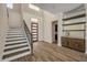 Bright foyer featuring hardwood floors, a modern staircase, and a custom dry bar at 212 Due East St, New Smyrna Beach, FL 32169