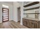 Bright foyer with hardwood floors, modern door, custom dry bar at 212 Due East St, New Smyrna Beach, FL 32169