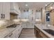 Modern kitchen boasts stainless appliances, white cabinets, stone countertops, and a central island with a wine refrigerator at 212 Due East St, New Smyrna Beach, FL 32169