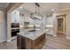 Bright kitchen featuring stainless appliances, white cabinets, a stone countertop island, and stylish pendant lighting at 212 Due East St, New Smyrna Beach, FL 32169