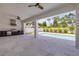 Expansive outdoor living space with a built-in kitchen and views of the sparkling pool and landscaped yard at 212 Due East St, New Smyrna Beach, FL 32169