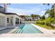 The large pool, travertine decking and built in BBQ area create a perfect outdoor living space at 212 Due East St, New Smyrna Beach, FL 32169