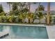 Gorgeous pool with lush landscaping, framed by a privacy fence, providing a serene and private oasis at 212 Due East St, New Smyrna Beach, FL 32169
