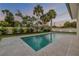 Inviting pool with tiled patio, lush landscaping, providing a relaxing outdoor space at 212 Due East St, New Smyrna Beach, FL 32169