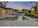 Exterior view of pool and outdoor living area with covered patio and lush tropical landscaping in the backyard at 212 Due East St, New Smyrna Beach, FL 32169