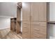 Spacious walk-in closet with modern cabinetry, shelving, drawers, and hardwood floors at 212 Due East St, New Smyrna Beach, FL 32169