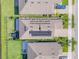 Aerial view of rooftops with solar panels installed on one house with low monthly payments at 220 Venetian Palms Blvd, New Smyrna Beach, FL 32168