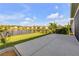 Well-maintained backyard featuring a lovely lake view and an iron fence at 220 Venetian Palms Blvd, New Smyrna Beach, FL 32168