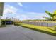 Spacious backyard with a lake view, a trampoline, and an iron fence at 220 Venetian Palms Blvd, New Smyrna Beach, FL 32168