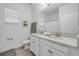 Bright bathroom featuring a double vanity, granite counters, and framed mirror at 220 Venetian Palms Blvd, New Smyrna Beach, FL 32168